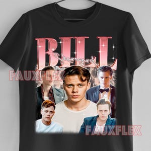 May include: Black t-shirt featuring a collage of images of Bill Skarsgård, with the name "BILL" in a pink, retro font. The shirt includes the text "FAUXFLEX" in white.