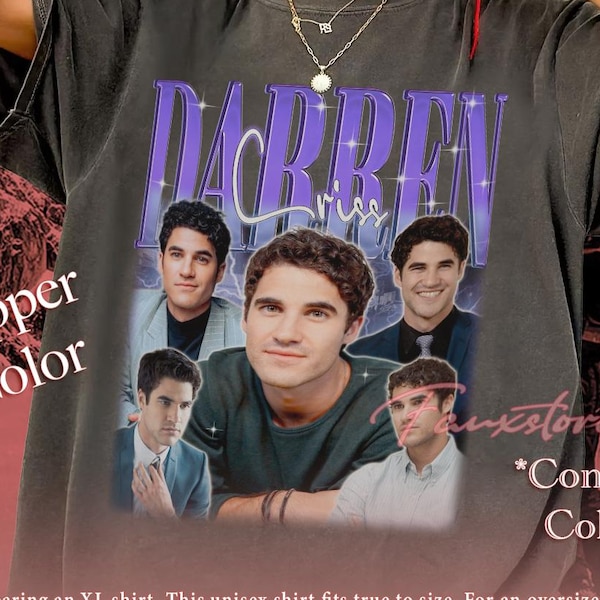 May include: A pepper-colored t-shirt featuring a graphic print of Darren Criss with the text "DARREN" in large purple letters and "Criss" in script. The design includes four distinct photographic portraits of the actor in various outfits.