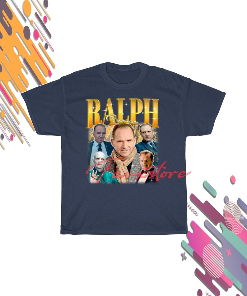 May include: Navy blue t-shirt with a gold-lettered "RALPH" design and multiple images of Ralph Fiennes. The portraits show the actor in different poses, creating a collage effect.