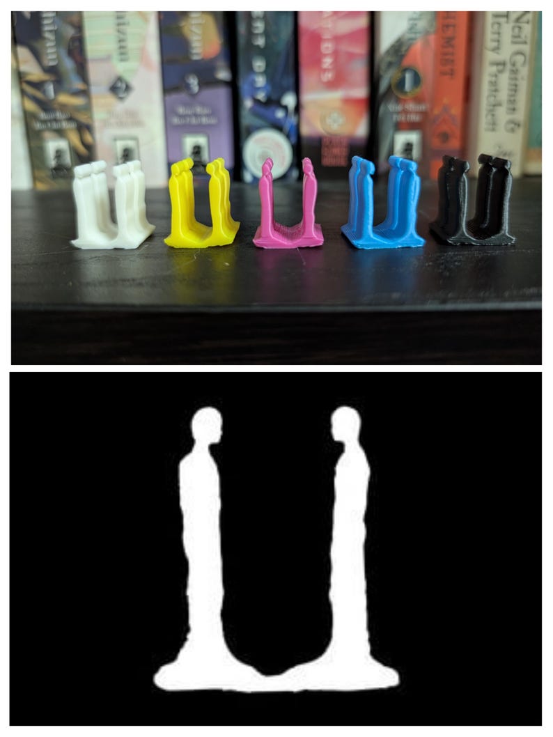 May include: A row of colorful bookends in white, yellow, pink, blue, and black. Each bookend has a unique design, with a U-shaped structure and a silhouette of two figures. The bookends are on a dark surface with books in the background.