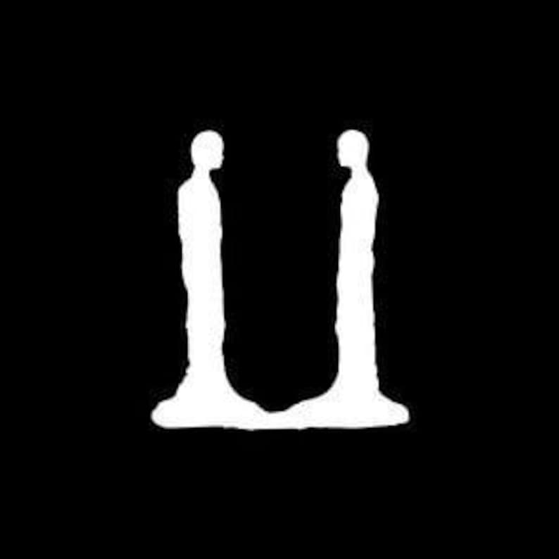 May include: A black and white minimalist art piece featuring two white human figures facing each other. The figures have elongated forms and are set against a stark black background, creating a striking contrast.