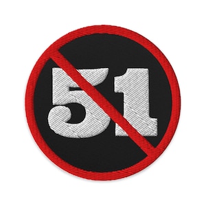 May include: Embroidered patch with a black circular background and a red border. The number '51' is displayed in white, crossed out by a red diagonal line. The patch has a textured, stitched appearance.