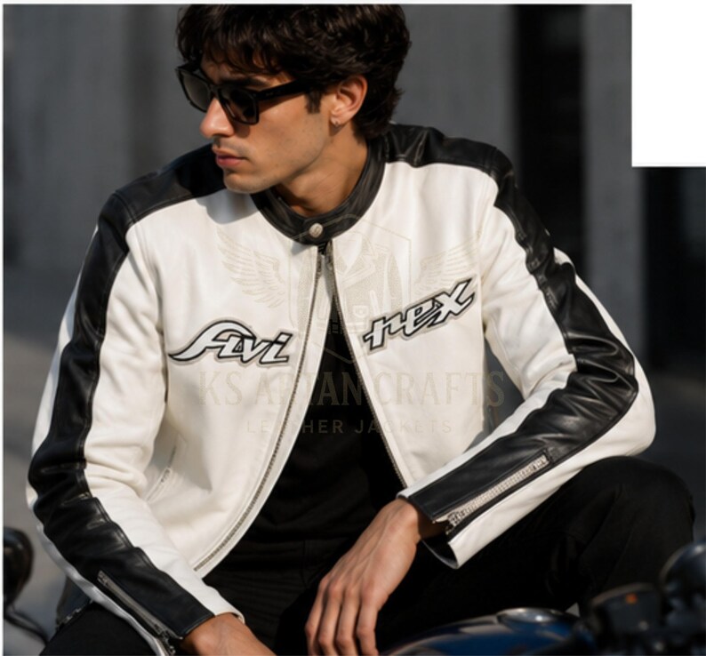 May include: A white and black leather motorcycle jacket with the text "Fivi" and "Rex" on the front. The jacket has black accents on the shoulders and sleeves, and a zipper closure. The jacket is worn by a person wearing sunglasses.