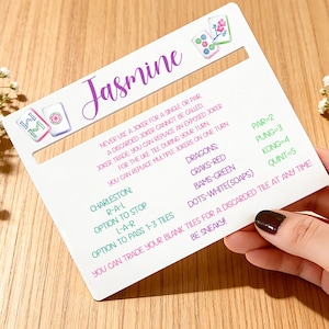 May include: A set of three ceramic mugs with a speckled, matte finish. The mugs are in shades of cream, light grey, and dark grey. Each mug has a simple, minimalist design and a rounded handle.