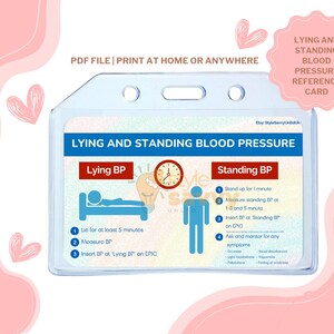 May include: A clear plastic card holder containing a reference card for lying and standing blood pressure. The card has blue and red text with illustrations of a bed and a person standing. Text includes "Lying BP" and "Standing BP".