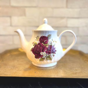 Floral teapot with lid in colorful pink, purple, red, green, and gold bone china
