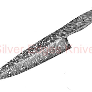 May include: A Damascus steel chef's knife with a swirling, marbled pattern in shades of gray and black. The blade has a sharp edge and a full tang. The text "Silver Knives" is visible.