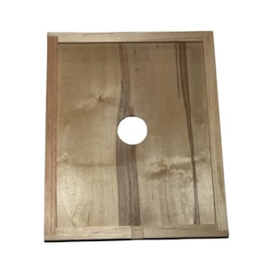 May include: A wooden beehive inner cover with a round hole in the center. The cover is made of light wood with a natural finish.