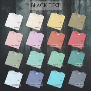 May include: A collection of sixteen crewneck t-shirts in various solid colors, each featuring a small embroidered script text that reads angel on the left chest. The colors include white, ivory, butter, khaki, blossom, orchid, terracotta, watermelon, bay, chalky mint, island reef, seafoam, chambray, washed denim, lagoon, and blue jean.