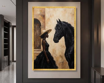May include: A vertical oil painting in a gold frame depicting a person wearing a wide-brimmed straw hat and a black dress standing beside a large black horse. The background features a beige wall and a dark arched doorway in a neutral color palette.