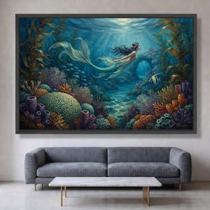 May include: A framed wall art print depicting an underwater scene with a mermaid swimming through a vibrant coral reef. The composition features deep blue water, tall golden kelp, colourful coral formations, and a small fish near a stone arch.