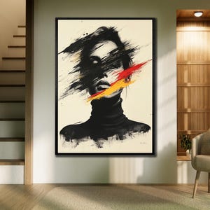 May include: Abstract art print of a woman's face with black brushstrokes obscuring the features. A slash of red and yellow paint crosses the face. The woman wears a black turtleneck. The artwork is framed in a black frame.