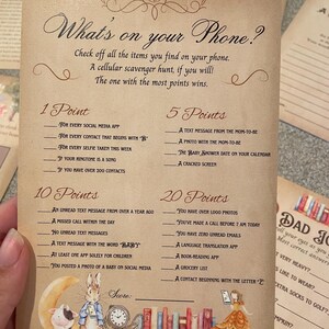 May include: A printable game card with a brown background and a list of items to find on a phone. The card is decorated with illustrations of a rabbit, a cow, and a bookshelf. The title of the game is "What's on your Phone?" and the points for each item are listed next to the item.