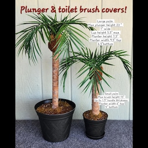 May include: Two artificial palm tree covers for a plunger and toilet brush. The large palm has a 23-inch max height, 9.5-inch top width, and 6.5-inch bottom width. The small palm has a 15-inch max height, 6-inch top width, and 4-inch bottom width.