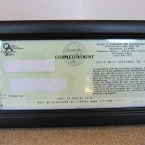 May include: A framed green and white California Cosmetologist license with the text "VALID UNTIL SEPTEMBER 30, 2008" and "POST IN PUBLIC VIEW - MUST BE DISPLAYED AT PRIMARY WORK STATION".
