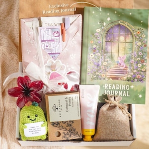 May include: A gift box containing a green reading journal, pink hand cream, a small hessian sack, soap, a crocheted green figure, and other items. The journal features a floral design and the words "Reading Journal".