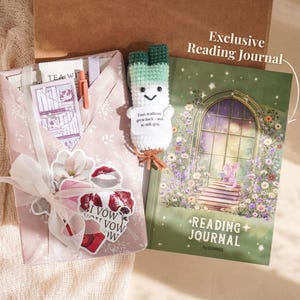 May include: A gift set with a pink envelope tied with a white ribbon, stickers, and a crochet scallion bookmark. A green and white reading journal with the text "Reading Journal" and "Exclusive Reading Journal" is also included.