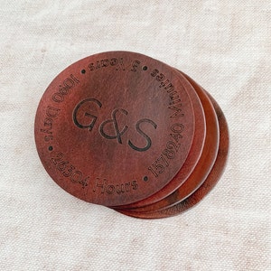 May include: Set of four brown leather coasters with engraved text: "Minutes 1578240, Hours 26304, Days 1090, 3 Years". The coasters feature the initials "G&S" in a decorative font.