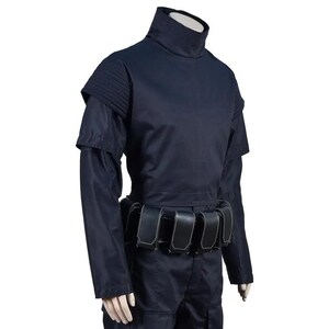 May include: A dark navy blue costume featuring a high collar, shoulder accents, and long sleeves. The costume includes a belt with multiple pouches. The outfit is made of a smooth, possibly synthetic fabric.