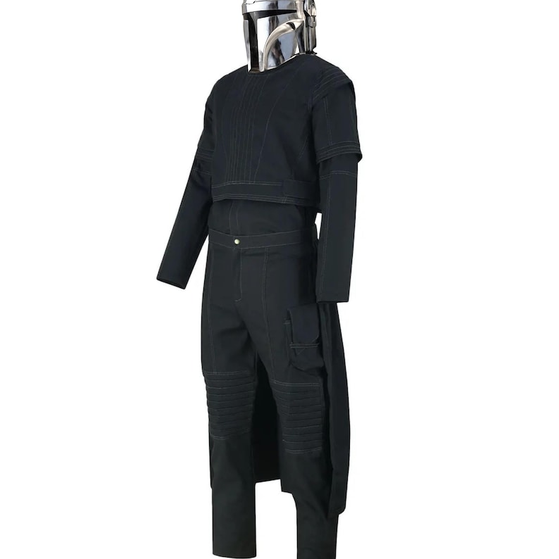 May include: A black costume with a silver helmet. The outfit includes a long-sleeved top, trousers with knee padding, and a long, flowing piece of fabric attached to the trousers. The helmet is shiny and reflective.