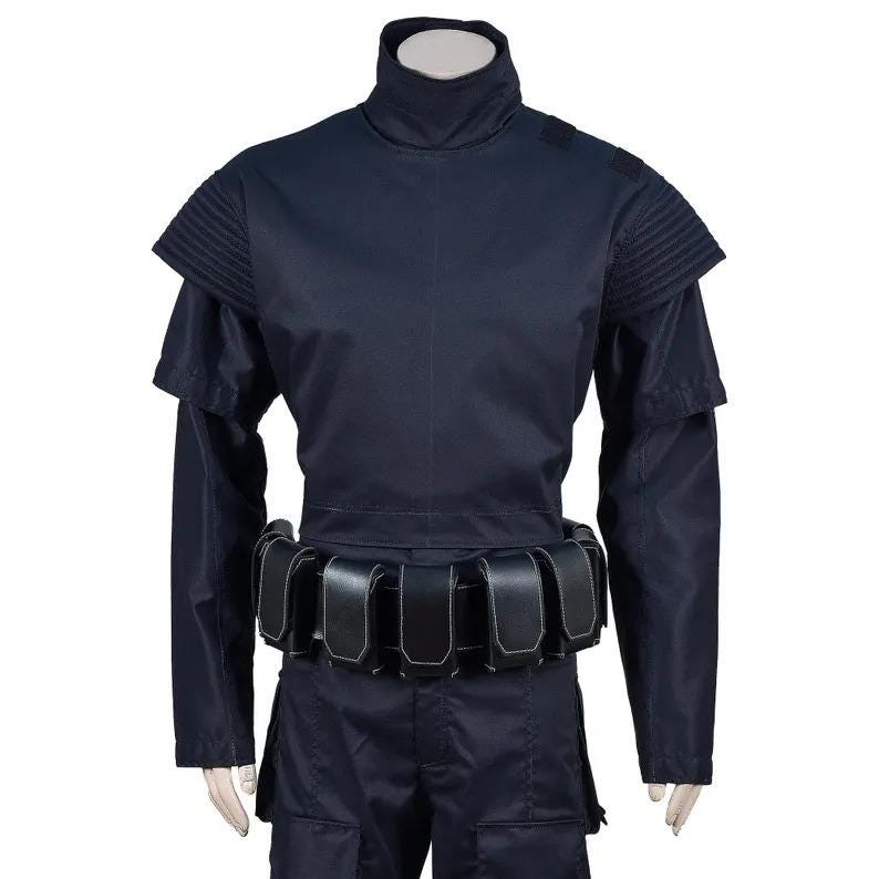 May include: A dark navy blue costume with a high collar and shoulder accents. The outfit includes a long-sleeved top, matching pants, and a utility belt with multiple pouches. The costume is designed for cosplay or themed events.