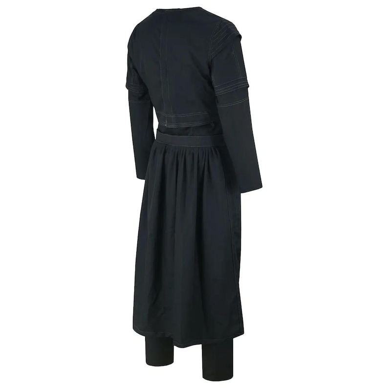 May include: A black outfit comprising a long-sleeved top with a waist detail, a long skirt, and fitted trousers. The top has a V-neck and the skirt is pleated. The outfit appears to be made of a dark fabric.