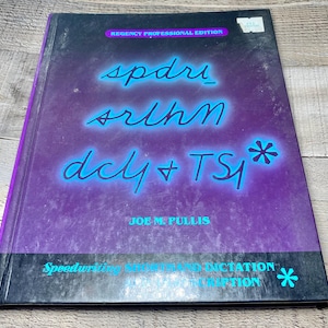 May include: A hardcover book with a purple and black cover. The title, in a stylized font, reads "spdri srihn dcy + TS*". The author's name, Joe M. Pullis, is below the title. The book is titled "Speedwriting, Shorthand and Dictation".