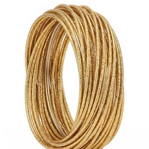 May include: A stack of gold-colored bangles. The bangles are tightly wound together, creating a thick, textured appearance. The gold color has a slight shimmer, reflecting light. The bangles are set against a white background.