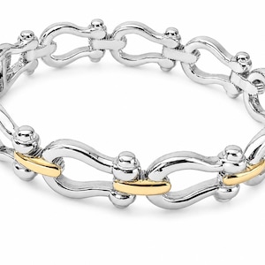 May include: A two-tone link bracelet featuring a repeating horseshoe-shaped design. The bracelet is constructed from polished silver-toned metal links connected by smaller, smooth gold-toned metal bars at each joint, creating a continuous circular chain.