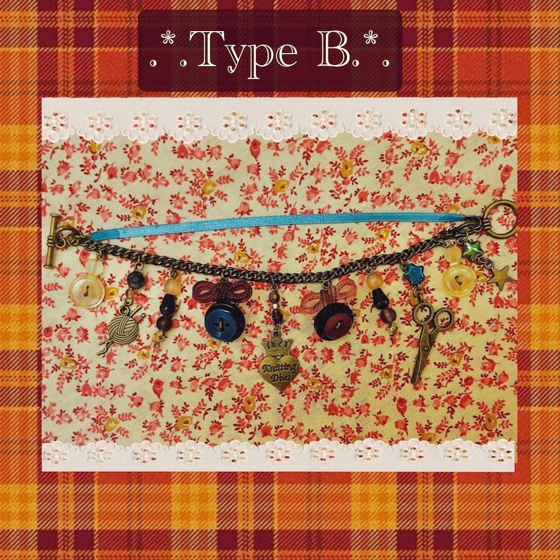 May include: A charm bracelet with sewing-themed charms, including buttons, scissors, and a yarn ball. The bracelet is attached to a blue ribbon and features a toggle clasp. The background is a floral pattern with the text "Type B."