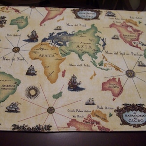 May include: A rectangular map-themed placemat with a vintage design. The map features continents labeled in various colors, compass roses, and sailing ships. The text "Mappamondo Globo" is visible.