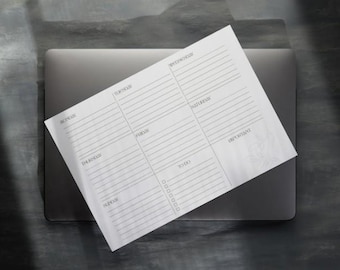 Könnte beinhalten: Ein weißer Wochenplaner mit floralem Design. Der Planer hat Abschnitte für jeden Tag der Woche sowie eine To-Do-Liste.