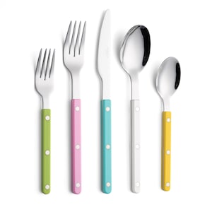 May include: A set of five stainless steel utensils with colorful handles. The set includes a fork with a green handle, a fork with a pink handle, a knife with a turquoise handle, a spoon with a white handle, and a spoon with a yellow handle. Each handle has white dot accents.