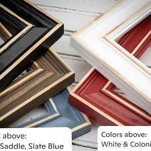 May include: A collection of wooden picture frames in various colors. The frames include black, saddle brown, slate blue, white, and colonial red. The text "Colors above: Black, Saddle, Slate Blue" and "Colors above: White & Colonial Red" is visible.