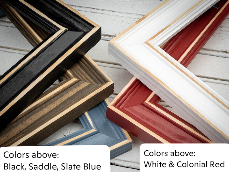 a group of frames sitting on top of a wooden floor