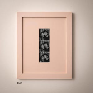 A framed collage of three black and white photographs of a couple, with the central photograph being a close-up of the couple's faces.