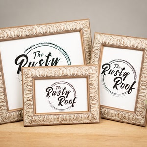 May include: Three rustic white and brown picture frames with a raised, textured design. The frames are all different sizes and feature a black and white logo that says "The Rusty Roof".