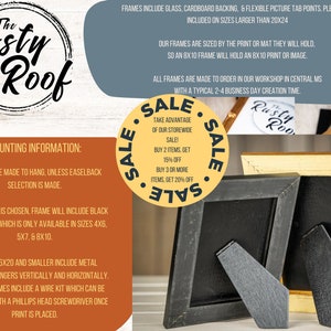 May include: A rustic wooden sign with the text "The Rusty Roof" in a circle. The sign is hanging on a wall with a black and yellow frame. The sign has information about mounting and frames. The text includes "Frames are made to hang, unless easelback selection is made." and "Frames include glass, cardboard backing, & flexible picture tab points. Plexiglass included on sizes larger than 20x24".