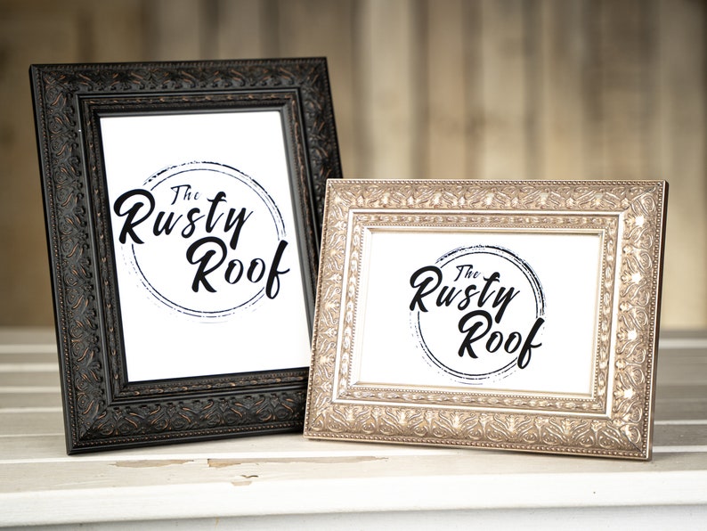 May include: Two ornate picture frames, one black and one gold, both with the same logo: "The Rusty Roof" in a circle with a grunge effect.