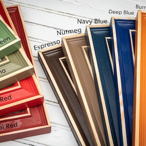 a group of different colored frames sitting on top of a table