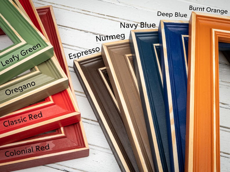 a group of different colored frames sitting on top of a table