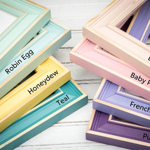 a group of different colored frames sitting on top of a table