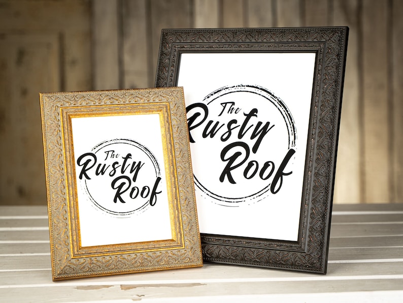 May include: Two ornate picture frames, one gold and one black, both displaying a white background with a black circle and the text "The Rusty Roof" in a stylized font.