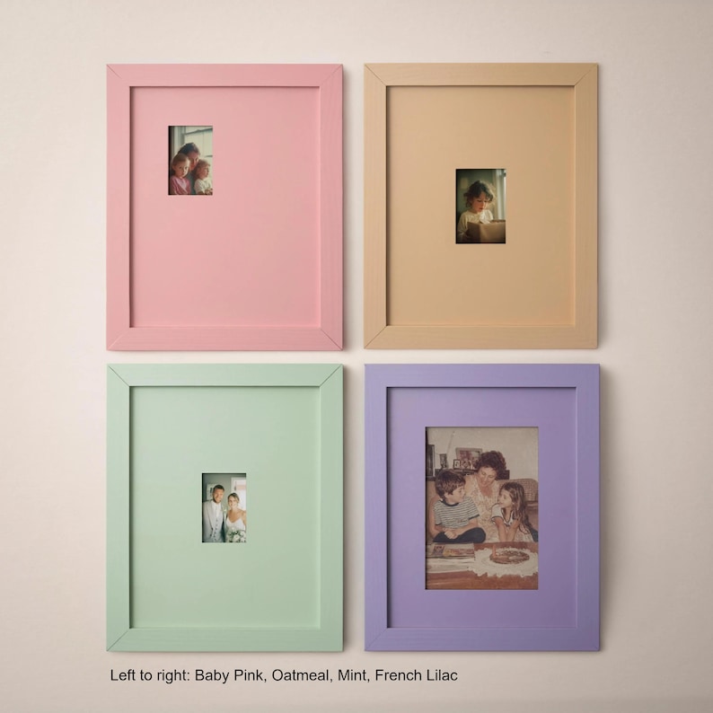 four framed pictures arranged in a grid on a wall, each with a different color frame.