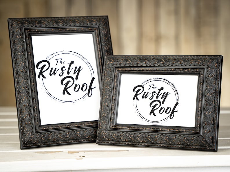May include: Two black ornate picture frames with the text "The Rusty Roof" in a circle on a white background.