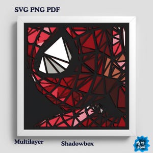 May include: A framed shadowbox artwork with a geometric design of a superhero mask in red, white, and black. The artwork is labelled "SVG PNG PDF", "Multilayer", and "Shadowbox".
