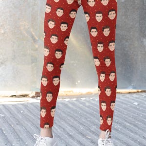 May include: Red leggings with a repeating pattern of a man's face.