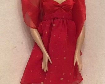 Gene wearing A Red and Gold Sparkly Cocktail Dress