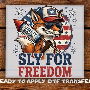 May include: A graphic featuring a cartoon fox wearing sunglasses and a baseball cap, holding a firework labeled "Liberty Boom." The text "Sly For Freedom" is below the fox, with "Ready to Apply DTF Transfer" at the bottom.
