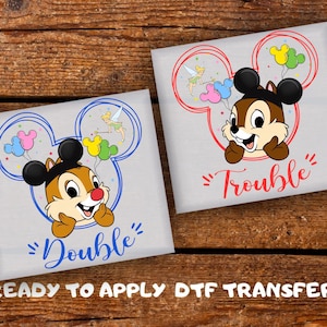 May include: Two gray DTF transfer sheets featuring Chip from Chip 'n Dale. One has a blue Mickey Mouse outline with the word "Double" and the other has a red Mickey Mouse outline with the word "Trouble". Both have Chip holding balloons and Tinkerbell.